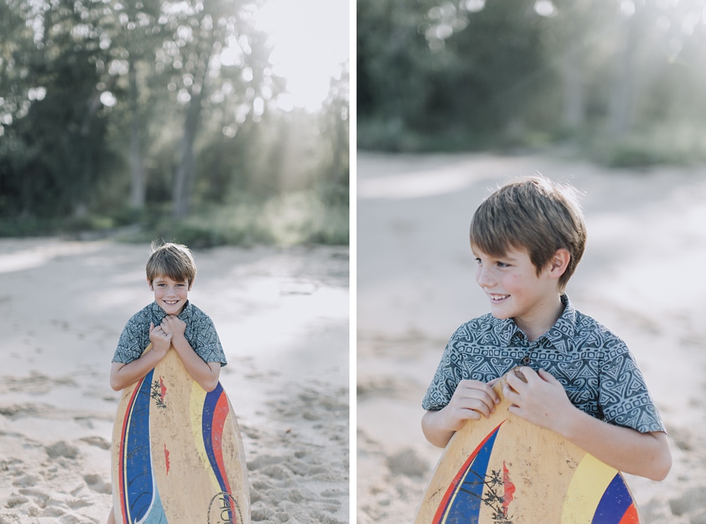 Boy holding Skimboard Baldwin Beach. 