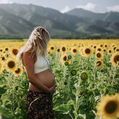 babymoon photo in the sunflowers on maui, hawaii