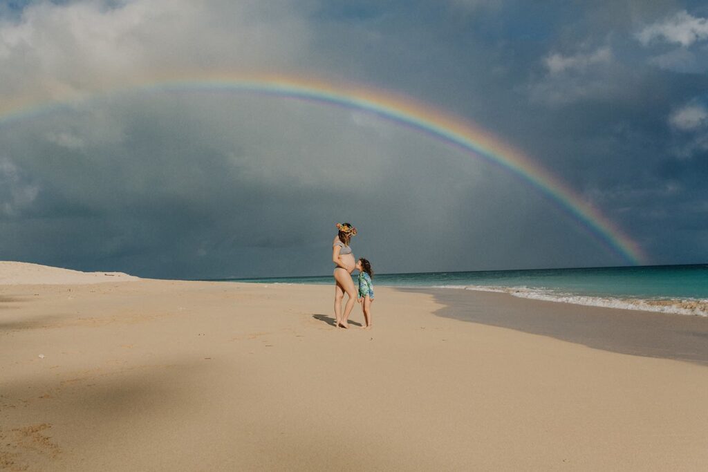 rainbow at baldwin beach during maternity photos in hawaii