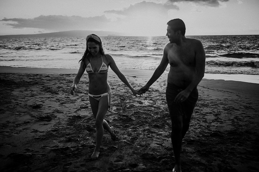 black and white photo of couple holding hands in wailea 